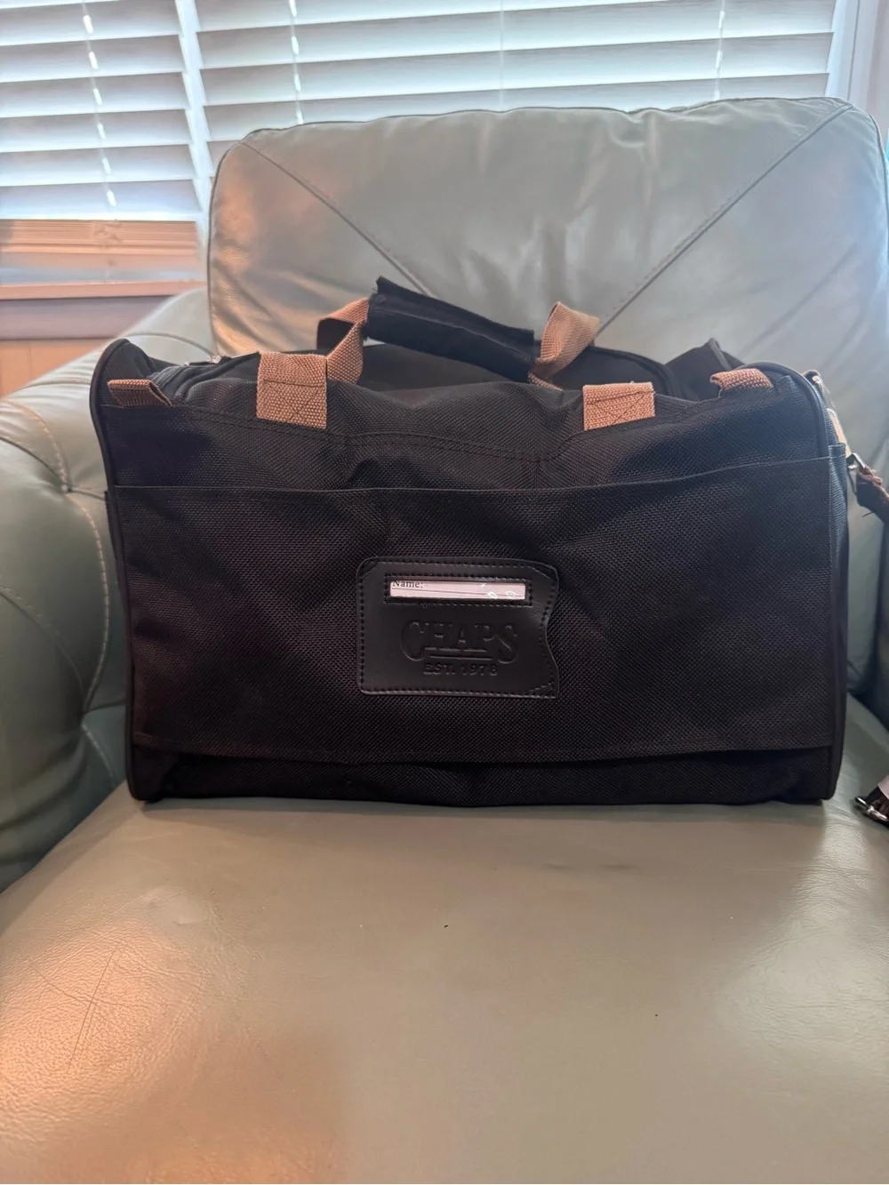 Chaps Black Duffel Bag with Tan Trim shoulder strap and double handle